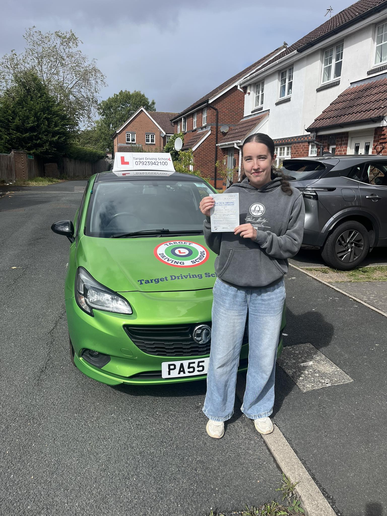 Young male student celebrating driving test pass with Target Driving School in Telford